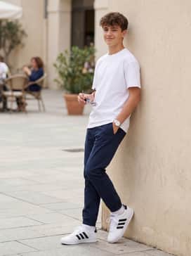 Style with beige chino shorts and a light blue linen button-down shirt for a smart-casual summer outfit perfect for daytime outings.