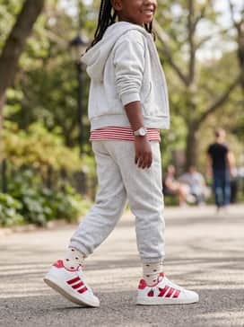 Light grey joggers and a matching zip-up hoodie for a comfortable and athletic daily playground look.