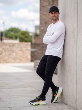 Gt Hustle 3 Deep Winter – An athletic-leisure vibe using tapered black tech-fleece joggers, a crisp white long-sleeve performance tee, and a matching black baseball cap.
