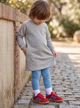 A simple gray jersey dress with bright blue leggings, echoing the shoe's accent colors for a cohesive outfit.