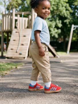 Handball Spezial Comfort Closure Elastic Lace Shoes Kids – Khaki chinos cuffed at the ankle with a graphic t-shirt featuring a subtle Disney print to tie the whole theme together.