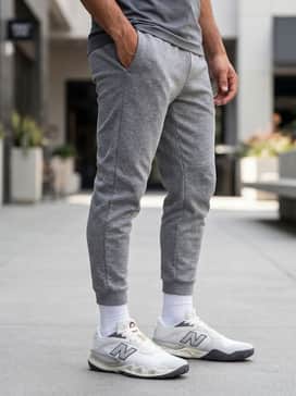Tapered tech-fleece joggers in heather grey, a fitted black performance quarter-zip pullover, and a matching silver-toned headband for a professional training look.