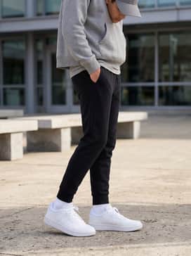 Hoops Shoes – A sleek athleisure outfit consisting of tapered black joggers, a heather grey cropped hoodie, and a matching baseball cap for effortless weekend style.