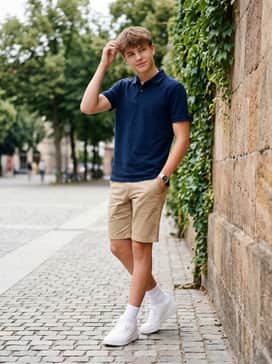 A crisp summer look pairing khaki chino shorts with a navy blue polo shirt or a breathable cotton button-down for a clean, preppy aesthetic.