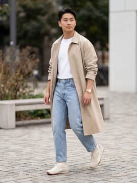 Hstreet Premium Sneakers – Light-wash straight-leg denim paired with a tucked-in premium white t-shirt and an oversized beige trench coat for a sophisticated tonal look.