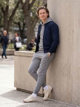 Hstreet Premium Sneakers – Heather grey tapered joggers and a matching slim-fit hoodie layered under a structured navy bomber jacket for a polished sporty ensemble.