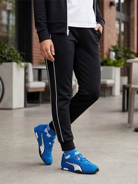 Hstreet Track  Field – Black slim-fit joggers with a matching sleek zip-up track jacket and a simple white sports bra for a coordinated athleisure ensemble.