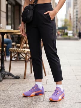 Black high-performance leggings and a cropped lilac hoodie, finished with a sleek crossbody bag for a coordinated and comfortable gym-to-brunch ensemble.