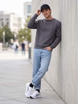 Hyper Speed 5 – A casual weekend outfit pairing slim-fit light-wash denim jeans with a simple charcoal crewneck sweatshirt and a black baseball cap for a relaxed, approachable vibe.