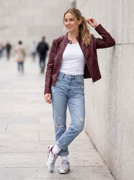 Hypersync – Distressed light-wash denim jeans and a white ribbed tank top topped with a burgundy faux-leather racing jacket to pull the shoe's accent colors together.