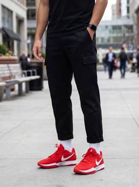 Ja 2 – A modern streetwear outfit with baggy black cargo pants, an oversized white graphic hoodie, and a silver chain necklace for a high-contrast urban aesthetic.