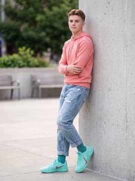 Ja 3 12 Time – Distressed light-wash denim jeans with a tucked-in coral-colored hoodie that echoes the warm tones in the iridescent swoosh.