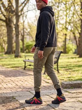 Ja 3 – Tapered olive cargo pants and a heavy-knit black hoodie, accessorized with a red beanie to pull together the various colors of the sneaker.
