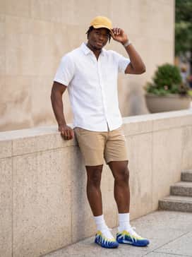 Ja 3 Murray State – Casual summer style pairing khaki chino shorts with a crisp white short-sleeve button-down and a yellow dad hat to pull the colors together.