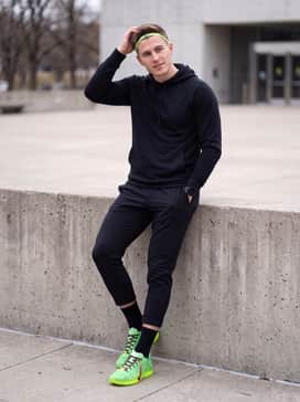 Ja 3 Spooky Season – A modern athleisure outfit with black tapered joggers, a matching fitted hoodie, and a neon green headband that echoes the shoe's vibrant upper.