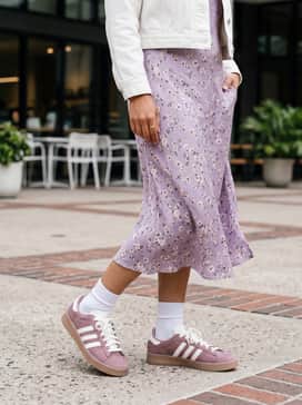 Jabbar Lo W Shoes – A midi-length lavender floral slip dress layered under a cropped white denim jacket for a feminine yet grounded aesthetic.