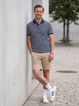Jabbar Og Low Shoes – Classic beige chino shorts with a navy-and-white striped polo and tall white crew socks to lean into a collegiate, preppy vibe.