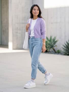 High-waisted light-wash 'mom' jeans paired with a cropped lavender cardigan that mirrors the shoe's purple accents, creating a cohesive and feminine look.