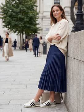 Style the sneakers with a pleated satin midi skirt in deep navy, a cream-colored oversized cashmere sweater, and dainty silver jewelry for a balanced feminine yet sporty outfit.