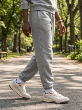 Jordan Flight Court – A grey oversized hoodie and matching heavyweight sweatpants set for a premium loungewear vibe, accented with dainty gold jewelry to elevate the relaxed silhouette.