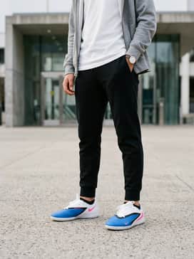A casual school ensemble consisting of black tapered joggers, a heather grey zip-up hoodie, and a basic white t-shirt.