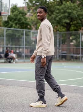 Kd18 Beyond The Game – A relaxed gym-to-street fit using wide-leg charcoal sweatpants, a vintage-washed beige graphic t-shirt, and a sleek neutral-toned baseball cap.