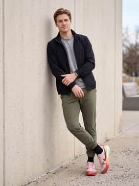 Match with tapered olive green joggers and a black zip-up windbreaker to create a balanced, street-ready athleisure ensemble that lets the colorful footwear pop.