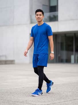 Kobe Ix Elite Low Em Protro – A professional on-court ensemble featuring black compression tights worn under royal blue mesh shorts, topped with a white moisture-wicking performance jersey.