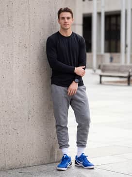 Kobe Ix Elite Low Em Protro – A clean athleisure outfit featuring grey tech-fleece joggers and a fitted black long-sleeve training top for a sleek, monochromatic base that highlights the shoes.