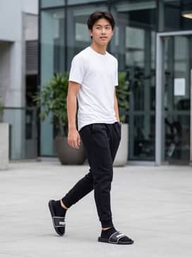 Athletic set featuring black tapered tech-fleece joggers and a moisture-wicking white performance tee for a post-gym cool down.
