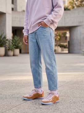 Lebron Xxiii – Relaxed-fit light-wash jeans paired with a pale lavender oversized sweatshirt for a soft, coordinated tonal look.