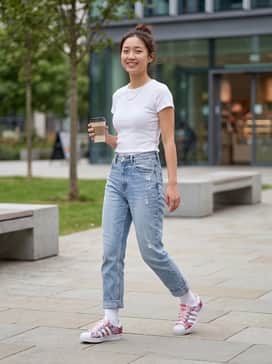 Liberty London Superstar Ii Shoes – High-waisted light-wash boyfriend jeans paired with a tucked-in white ribbed baby tee and a delicate silver necklace for a classic, clean look that lets the shoes pop.