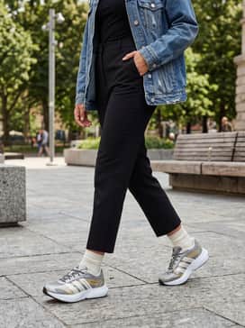 Lightblaze Glow Shoes – A sleek black jersey midi dress worn with an oversized distressed denim jacket and silver-toned jewelry to highlight the shoe accents.