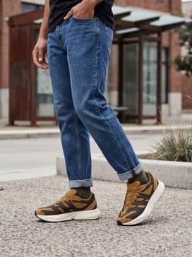 Lightblaze Shoes – Tapered black joggers and a crisp white premium t-shirt layered under a tan flannel shirt for a balanced athleisure look.