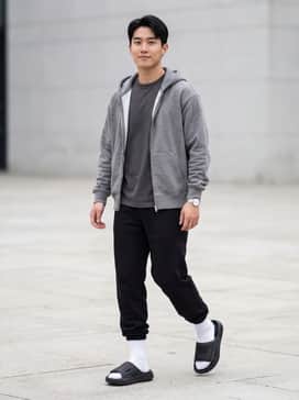 Lightblaze Slides – Black tapered fleece joggers paired with a grey heathered zip-up hoodie and white mid-calf crew socks for a classic athletic aesthetic.