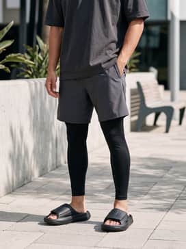Lightblaze Slides – Medium-wash relaxed-fit denim shorts and an oversized vintage graphic t-shirt in charcoal for an effortless summer streetwear look.