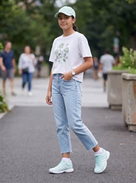 Ligra 8 Indoor Shoes – A relaxed weekend outfit with light-wash cropped straight-leg jeans, a boxy white graphic t-shirt, and a mint green baseball cap to match the footwear.