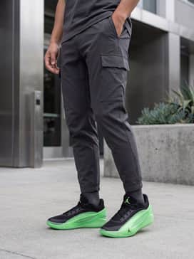 Luka 5 Venom – An edgy techwear ensemble consisting of black tapered tactical cargo pants, a black mock-neck tech tee, and a utility vest with subtle lime green detailing.