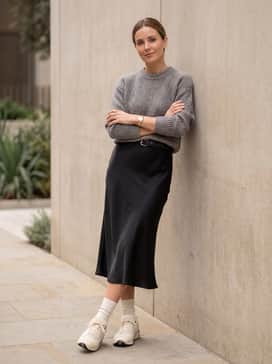A black satin midi slip skirt layered with a chunky grey marl sweater to contrast the sleek texture of the shoe with soft knitwear.