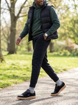 Combine with black tech-fleece joggers, a graphic hoodie in a neutral tone, and a puffer vest for a modern streetwear aesthetic.