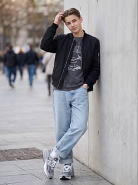 Made In Usa 990v6 – Style with oversized light-wash denim jeans, a vintage graphic t-shirt, and a black bomber jacket to lean into classic streetwear vibes.