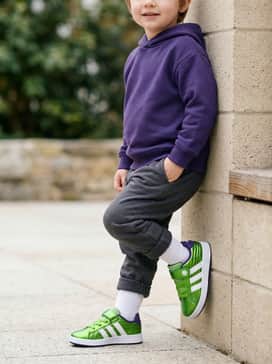 A cozy purple hoodie over charcoal gray joggers, creating a coordinated color story with the shoe's accents.