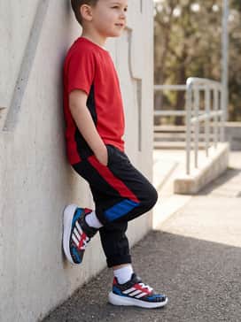 Marvel Spiderman Runfalcon Shoes Kids – Red and black color-blocked track pants with a matching moisture-wicking athletic top for sports practice or physical education class.