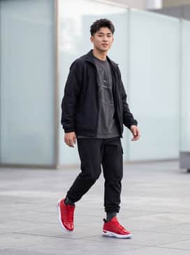 Max Aura 7 – Black tapered tech-cargo pants paired with a charcoal oversized graphic tee and a black windbreaker to make the varsity red patent leather stand out as a bold focal point.