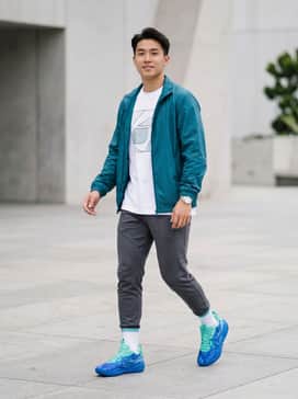 Pair with tapered charcoal joggers, a crisp white oversized graphic tee, and a matching teal nylon windbreaker for a cohesive athletic-inspired look.