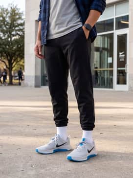 A casual weekend ensemble consisting of slim-fit light wash denim jeans, a crisp white heavyweight cotton t-shirt, and an unbuttoned navy blue flannel shirt.