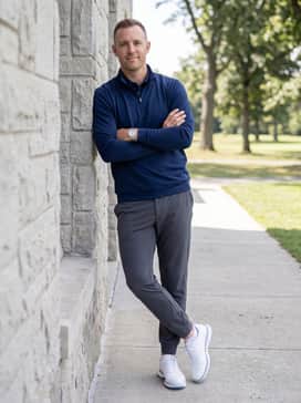 Mc70 Spikeless Golf Shoes – Charcoal grey tapered joggers with a breathable navy quarter-zip pullover for a modern, sporty aesthetic on cooler days.