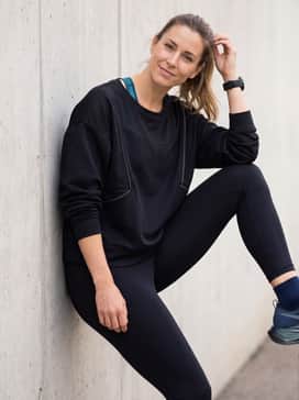 Megablast – High-performance black leggings, a teal-accented sports bra, and an oversized mesh-detailed sweatshirt for a functional yet stylish athleisure ensemble.