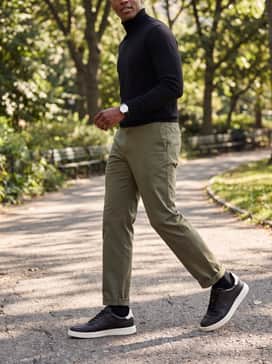 Mens Grand Crosscourt Daily Court Sneakers – Olive green tailored chinos matched with a black merino wool turtleneck and a minimalist silver-toned watch for a sophisticated evening aesthetic.