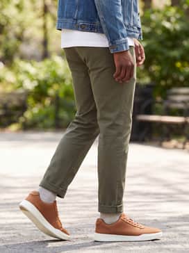 Mens Grand Crosscourt Modern Tennis Sneakers – Olive green tapered chinos with a premium white t-shirt and a classic denim jacket for an elevated take on relaxed weekend streetwear.